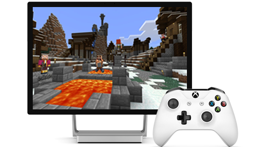 En Surface Studio-skærm vises, med Minecraft på skærmen, sammen med en Xbox-controller.