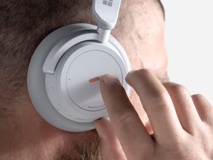 A man feeling the bump label on his headphones.