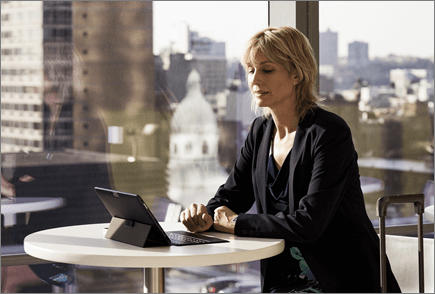 Woman in airport working on laptop computer