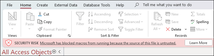 Security risk message displayed below the ribbon in an Access database with a Learn More button