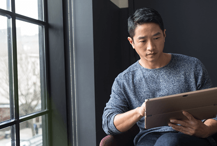 Male achieving in modern workplace with laptop.