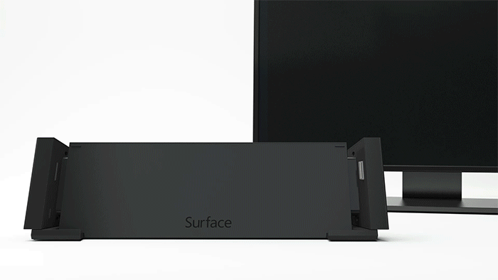 動畫圖形指出向下滑入連接基座的 Surface 裝置及該連接基座後方的螢幕。此螢幕開啟後顯示的影像與 Surface 上的影像相同。